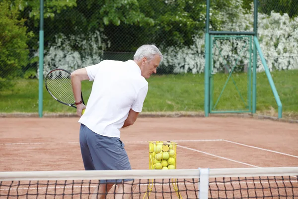 Tennis coach playing tennis