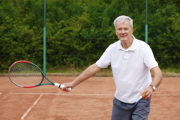 Senior man playing tennis