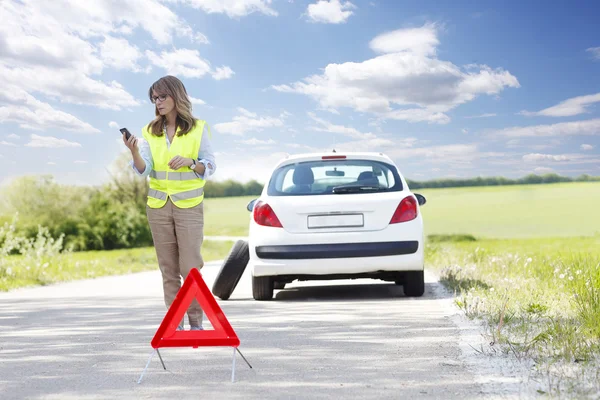 Woman calling roadside assistance.