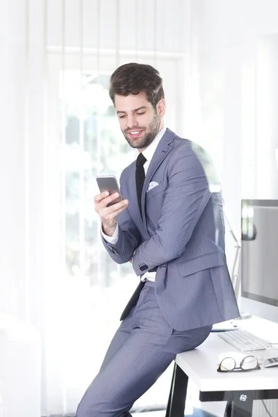 Bank assistant using his mobile phone