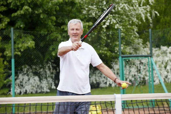 Man serving tennis ball