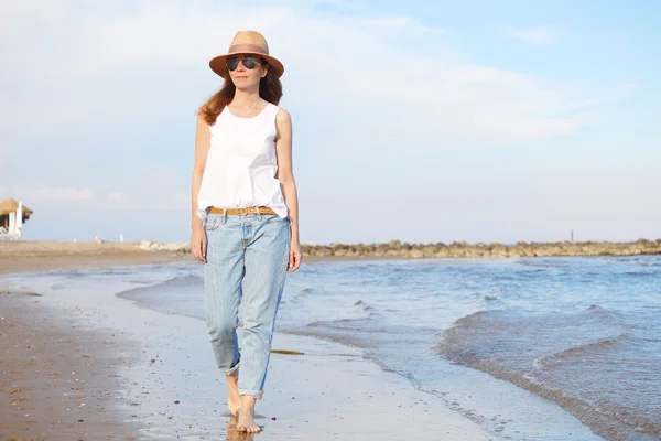 Woman  walking on the beach.