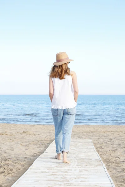 Woman walking  on the beach