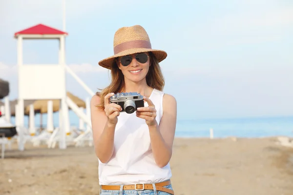 Woman using her vintage camera.