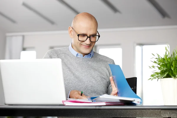 Businessman analyzing data on laptop