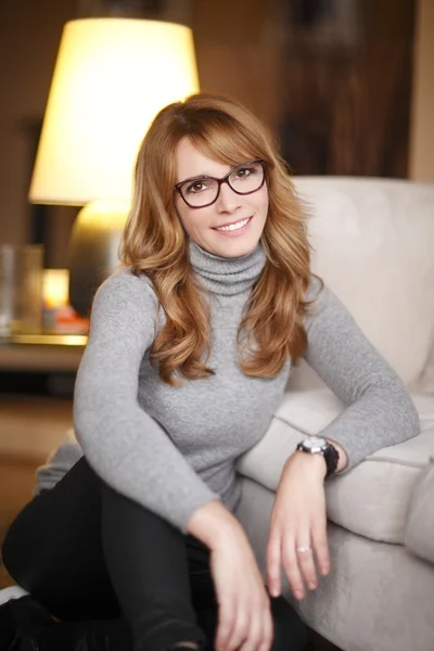 Mature woman sitting on sofa