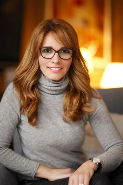 Mature woman sitting on sofa