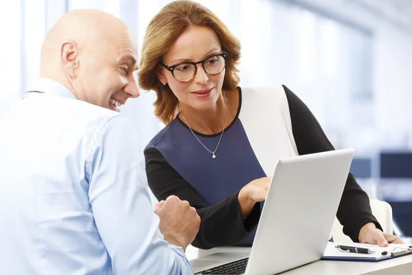 Financial officer analyzing data with businesswoman