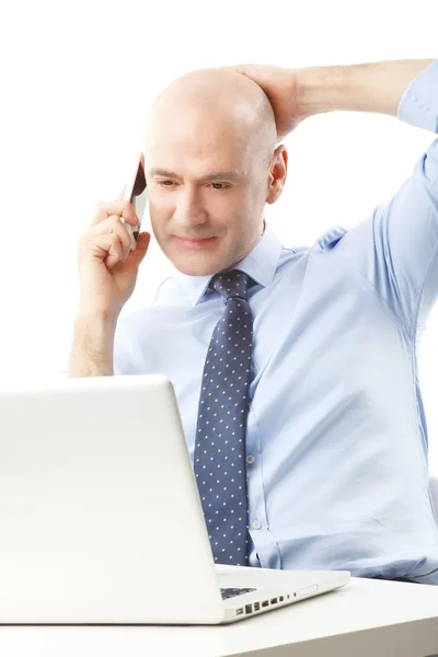 Businessman at office making call