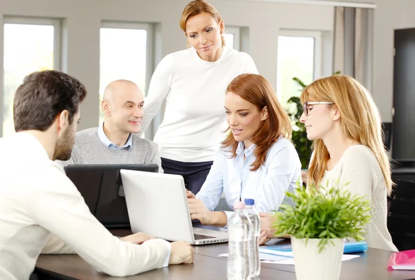 Business people sitting around conference table