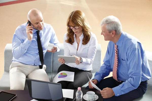 Businesswoman consulting with business people at meeting
