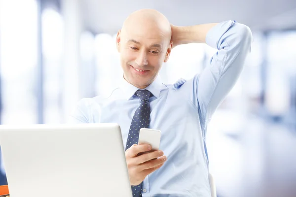 Middle age businessman holding phone