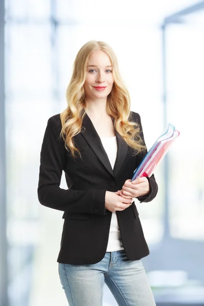 Female student holding files in hands