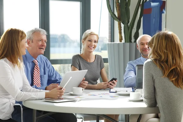 Business team sitting around at conference table