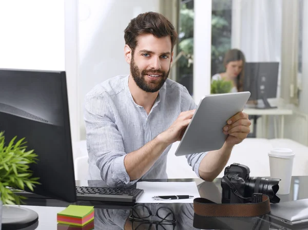 Creative professional man holding tablet