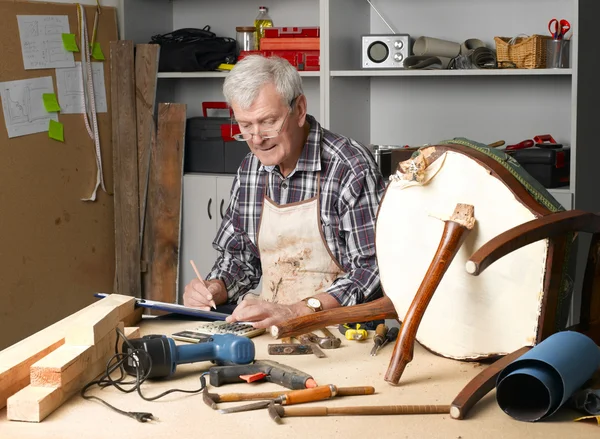 Senior carpenter working at his worshop
