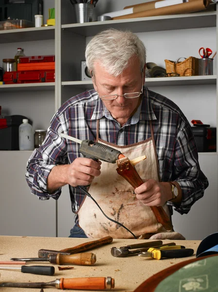 Retired man working at his workshop