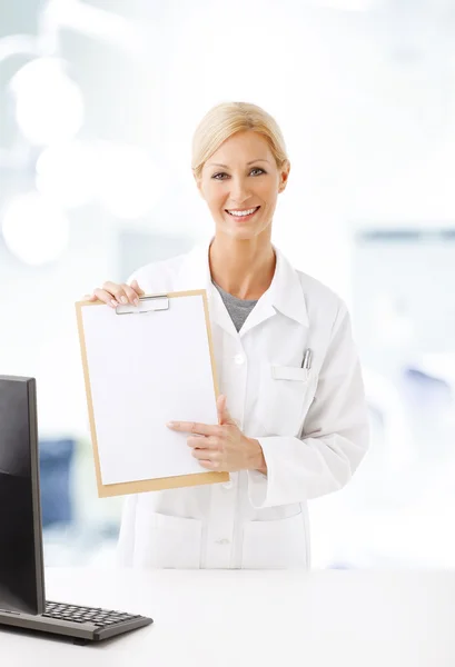 Health care worker holding hand clipboard