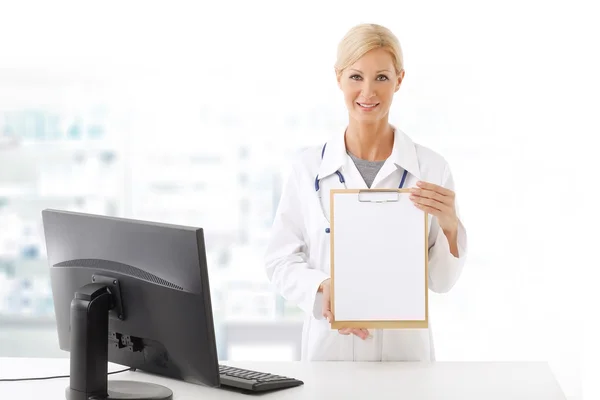 Health care worker standing in front of computer