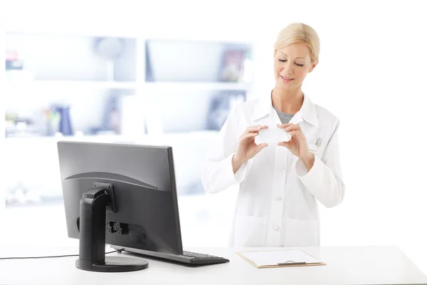 Pharmacist standing in front of computer