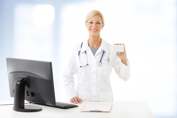 Health care worker standing at working desk