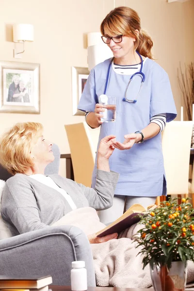 Home care nurse giving medication