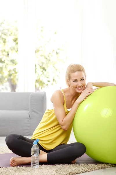 Woman with exercise ball sitting