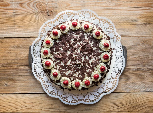 Black Forest cake on rustic wood