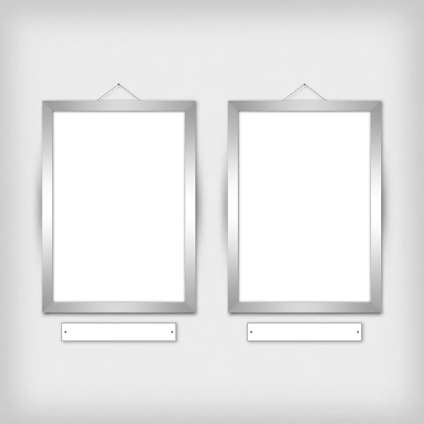 Two empty frames on a wall