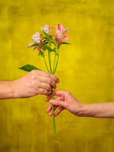 Man giving flowers to woman