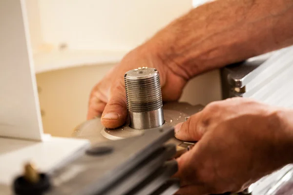 Hand of a woodworker setting up a milling cutter