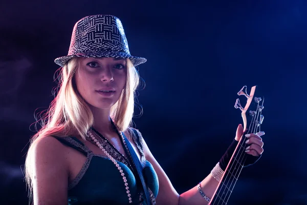 Young woman performing live as guitar player