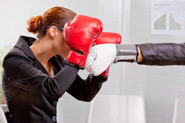 Boxing business woman defending from a punch