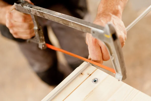 Hacksaw used by a carpenter