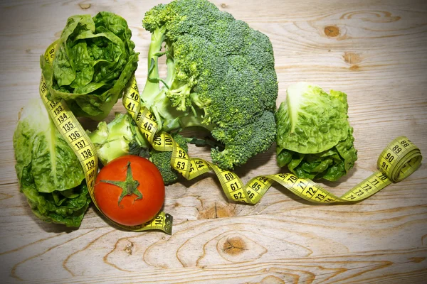 Tape measure with tomatoes, vegetables and apples