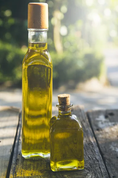 Bottles of olive oil on old wood