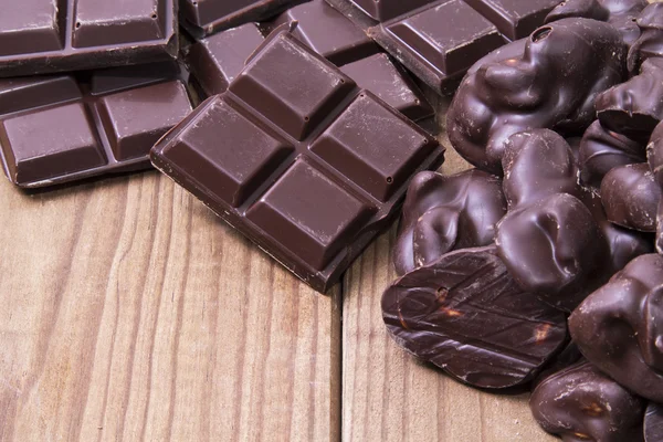 Black chocolate on wooden background