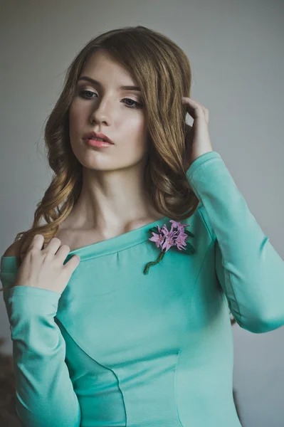 Studio portrait of a girl in a turquoise dress 4443.