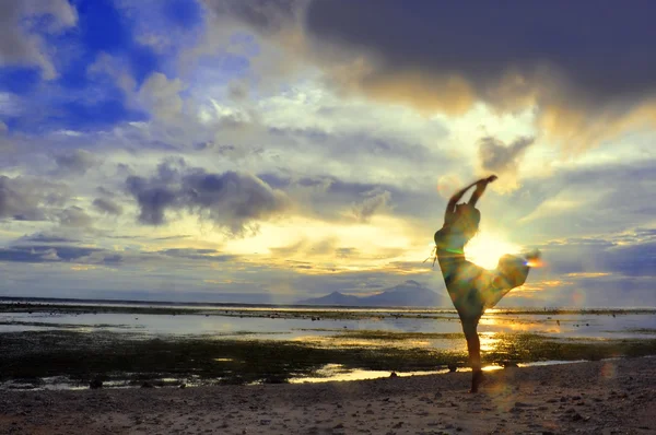 Woman dance at the Sunset over Bali as seen from Gilli
