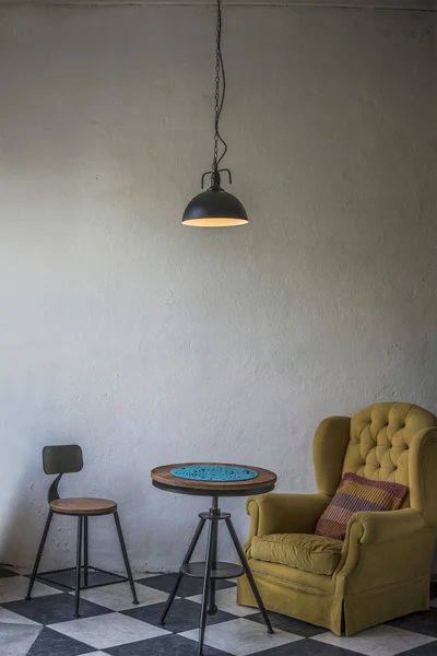 Vintage hipster loft interior with yellow armchair