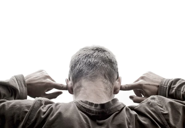 Young man turned back and has his fingers in his ears