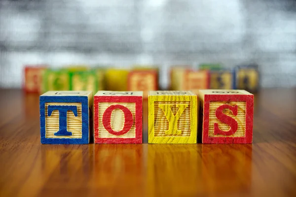 Word of TOYS spelled with colorful wooden alphabet blocks.Selective focus,shallow depth of field.