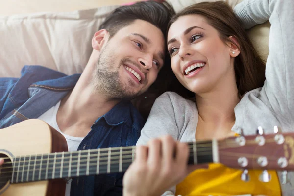 Couple playing guitar