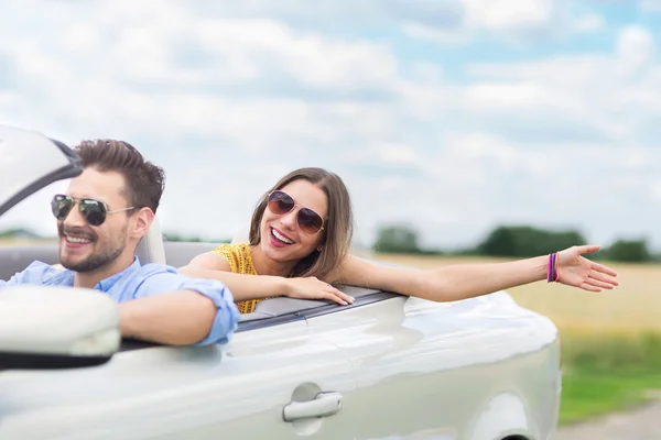 Happy Couple Driving in Convertible