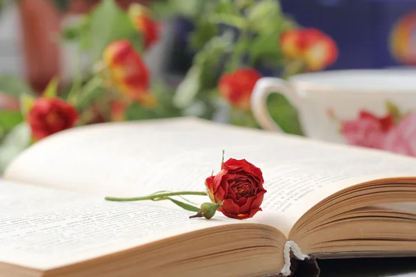 Still life with tea, books and roses