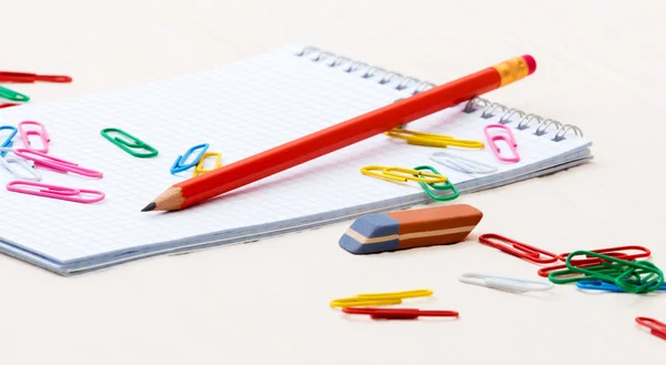 Notebook pencil paper clips on a desk