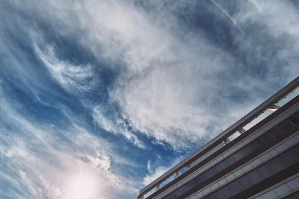 Beautiful clouds in blue sky with the modern architecture office building