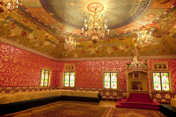 Interior of the wooden palace of Tsar Alexei Mikhailovich in Kolomenskoye. The interior of the dining room in a traditional bright red with gold decoration