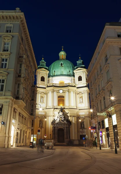 The Peterskirche ( St. Peters Church ) at night.  Roman catholic parish church in Petersplatz on Graben street. Vienna, Austria.