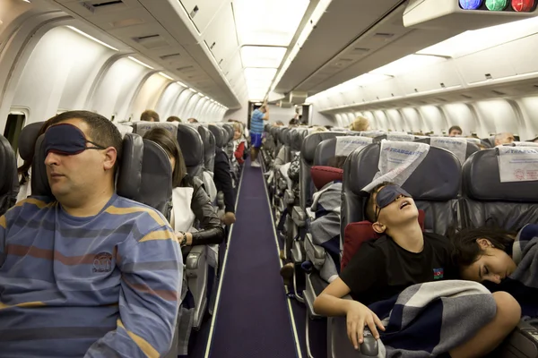 The passengers are sleeping in the cabin in flight.